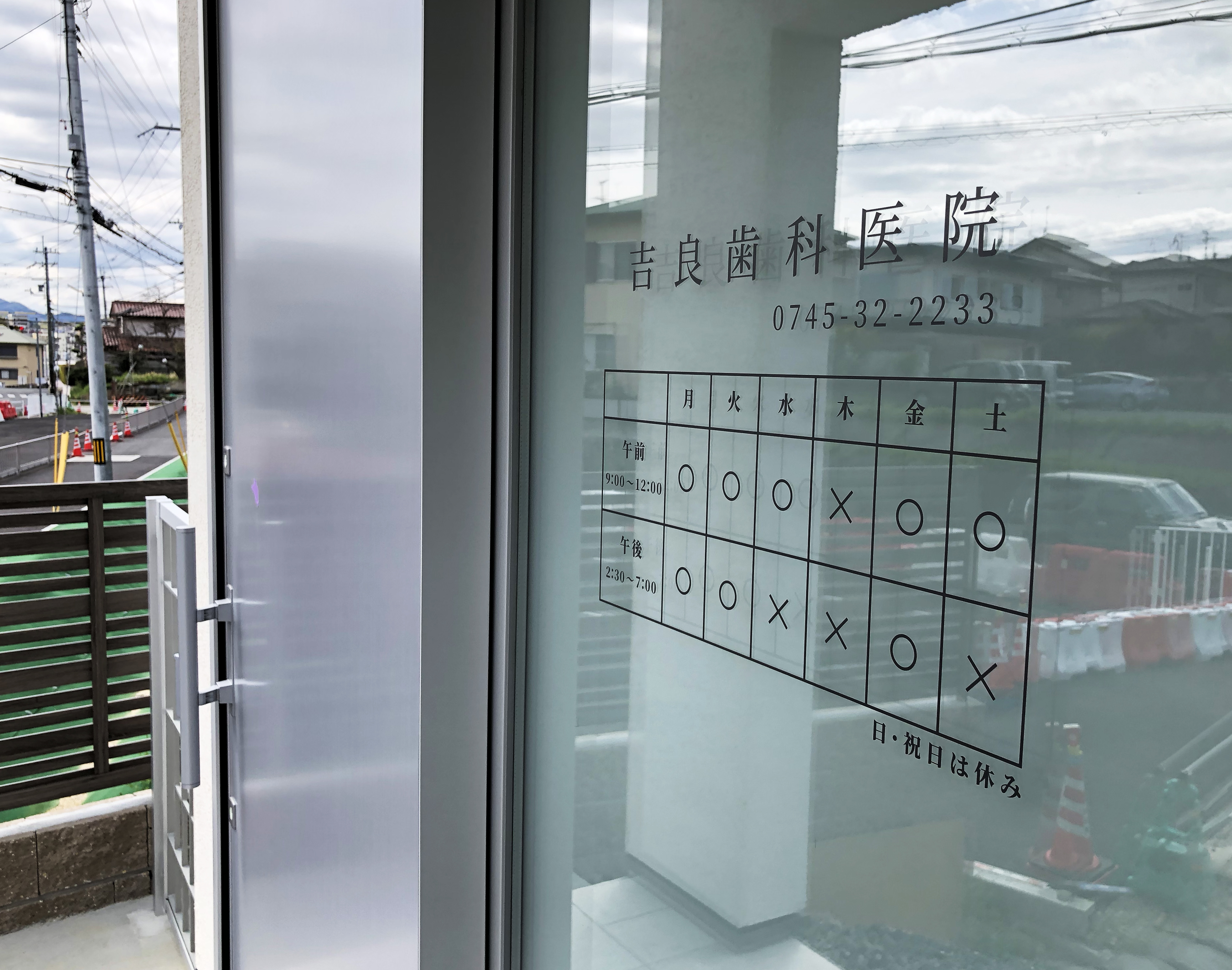 医院名と診療時間を表示した吉良歯科医院の入口サイン